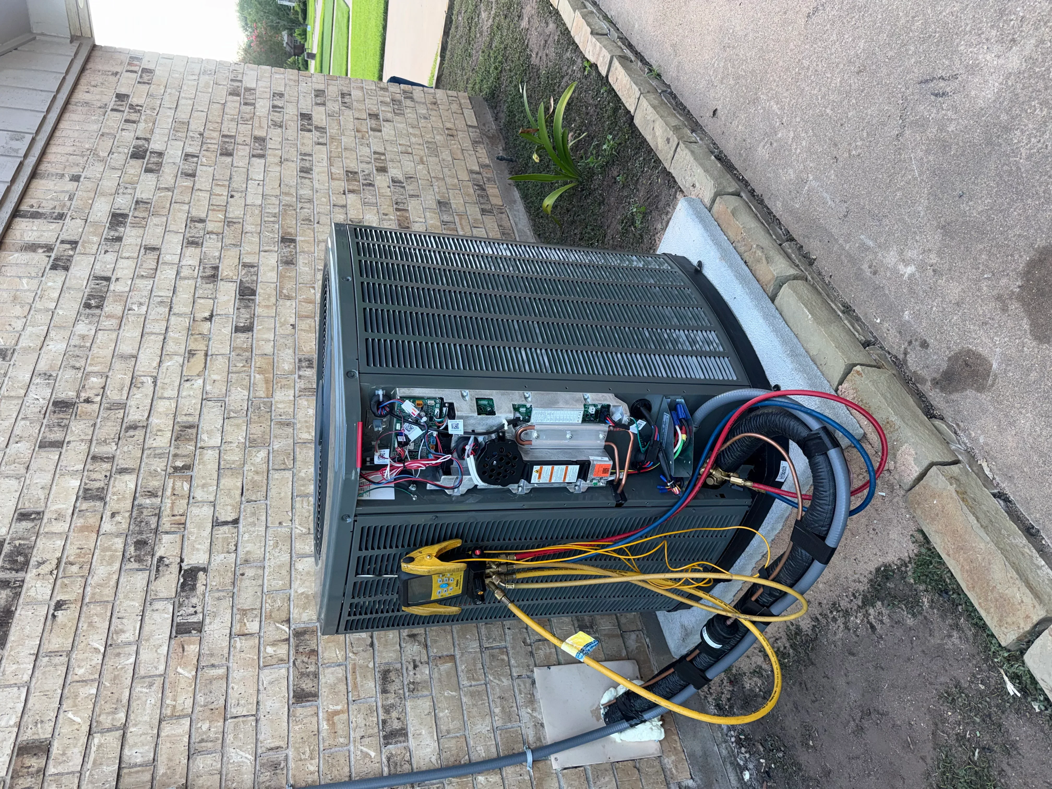 Heat pump unit with internal components, refrigerant lines, and electrical wiring during installation